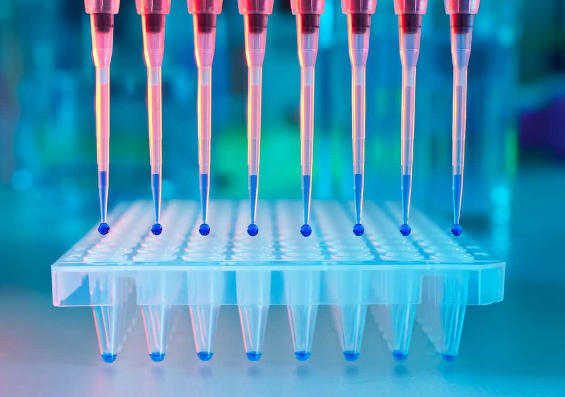 Pipettes dropping liquid in a lab